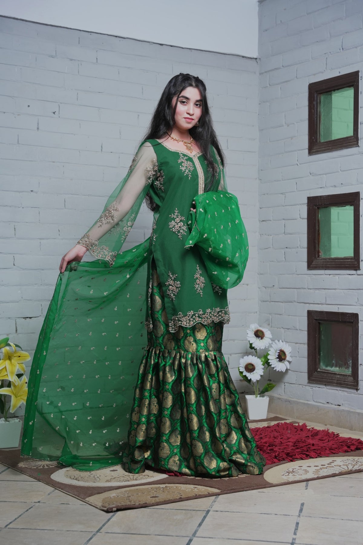 Green organza dupatta displayed with embroidered shirt and gharara
