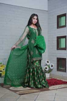 Green organza dupatta displayed with embroidered shirt and gharara