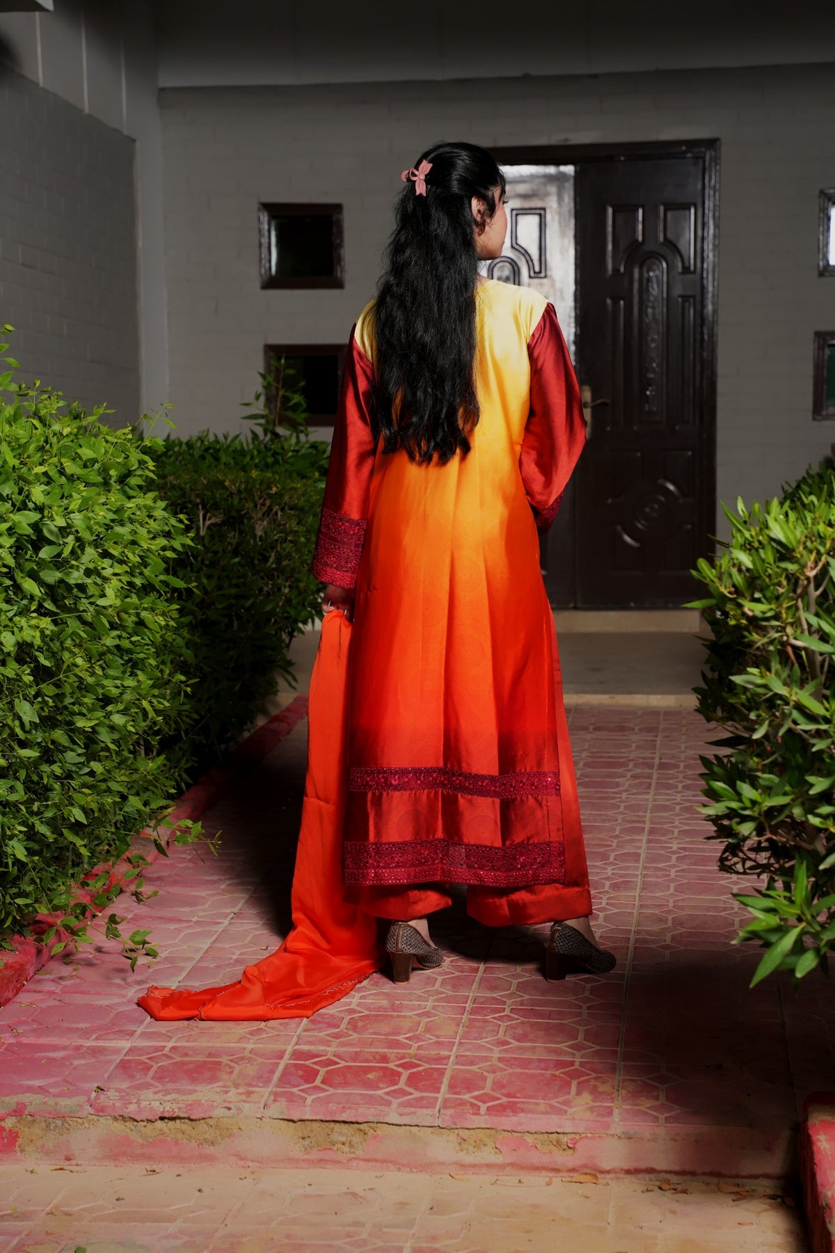 Orange-red gradient silk suit — back view