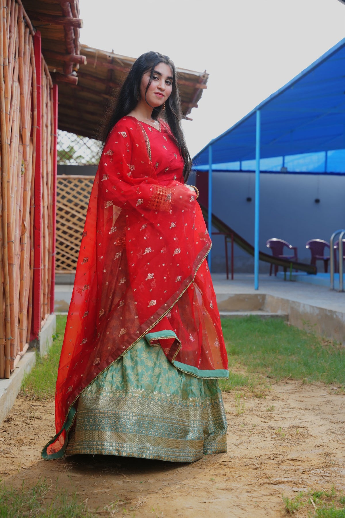 Fizza red and ferozi Banarsi lehenga set — side view